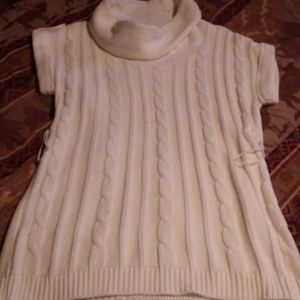 Creamy white sleeveless turtle neck long sweeter.